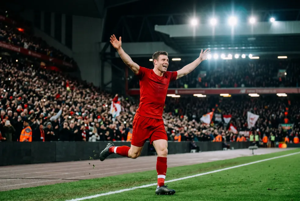 Jogador de futebol a celebrar um golo num estadio da Champions League
